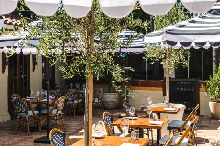 Patio under striped umbrellas at Capriciano Osteria