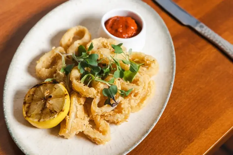 Calamari Fritti with grilled lemon, microgreens and a red aioli dip at Capriciano Osteria