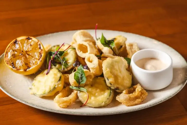 Close-up of Calamari Fritti with fried zucchini and microgreens at Capriciano Osteria