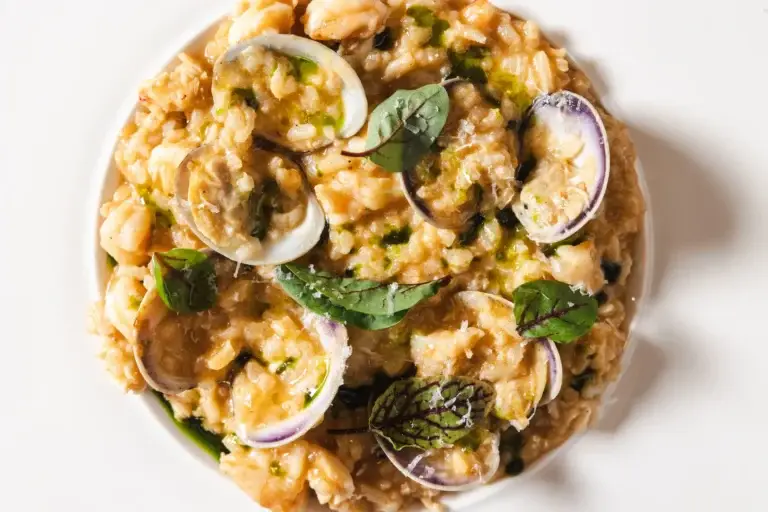 Blog 16 Close-up of Risotto ai Frutti di Mare with clams, shrimp and basil, seen from above, at Capriciano Osteria