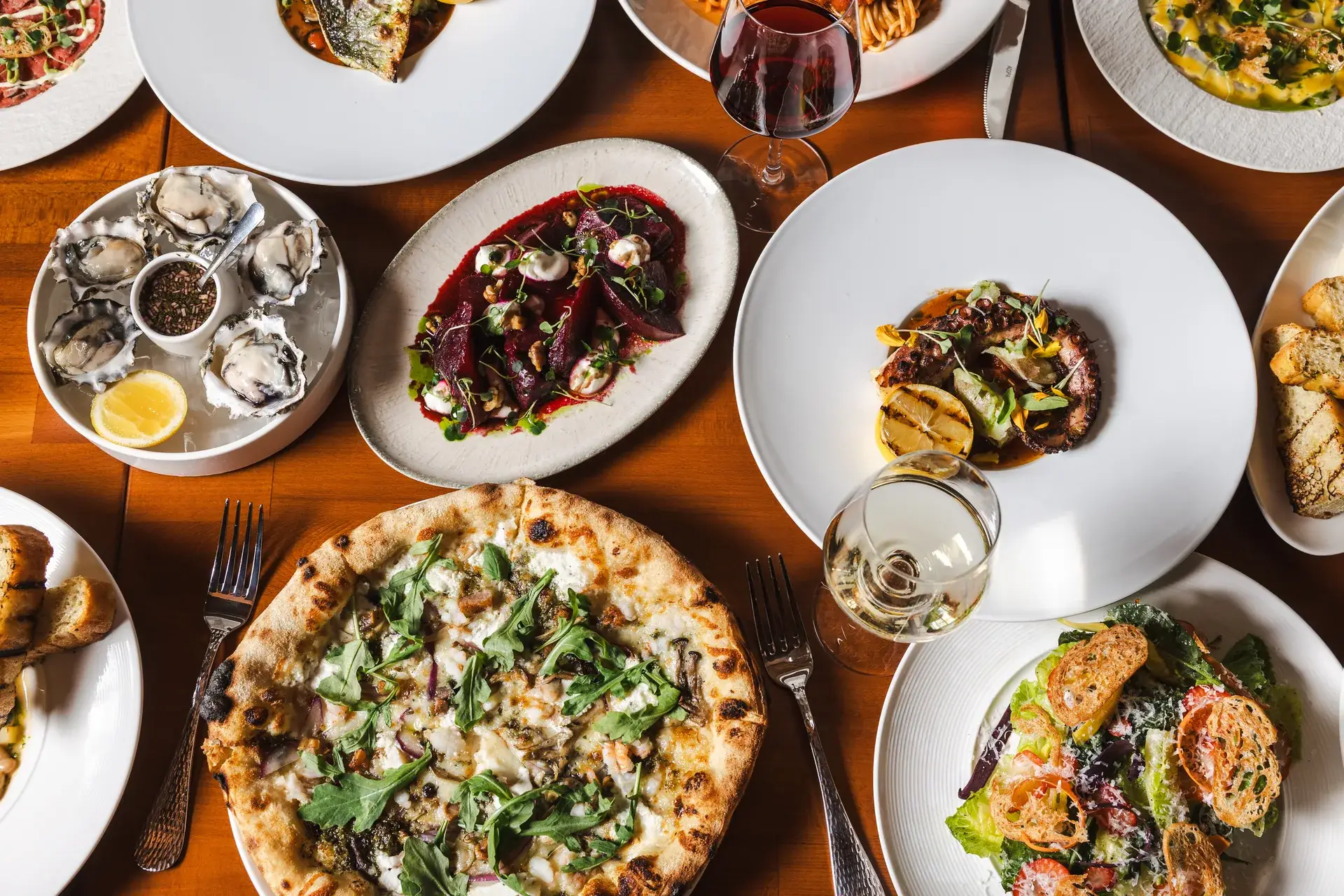 Oysters, beet salad, grilled octopus and a white pizza on one table, an Italian dinner in Santa Rosa at Capriciano Osteria