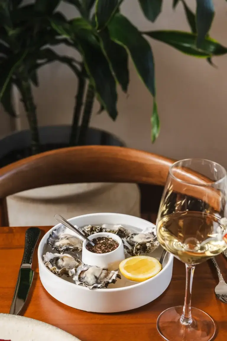 Oysters and a glass of white wine, an Italian aperitivo in Santa Rosa at Capriciano Osteria
