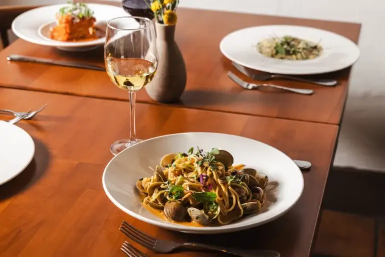 Spaghetti with clams and a glass of white wine at Capriciano Osteria